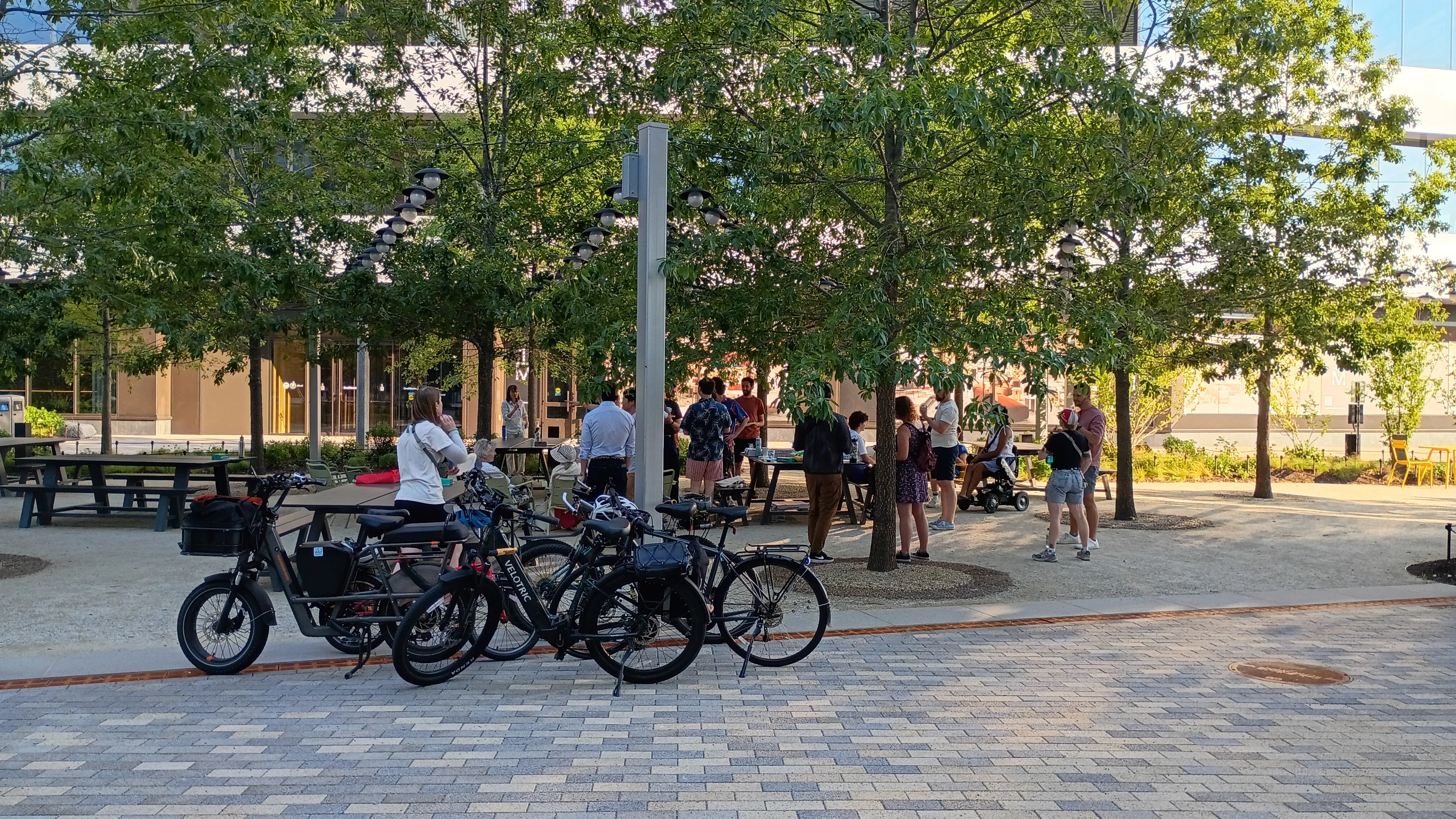 Gathering around the Allstonway picnic tables